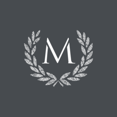 A white letter "M" is centered between two laurel branches forming a wreath on a dark gray background.